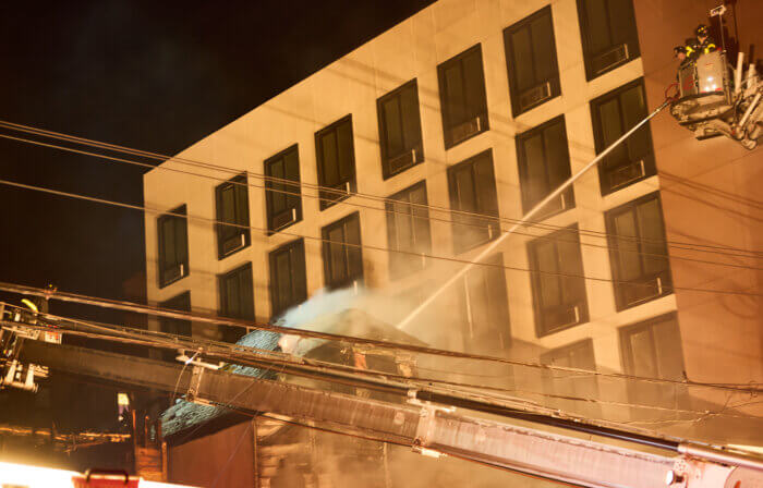 Tower Ladders 44 and 45 operates their streams to knock down heavy fire in two vacant buildings at 1041 and 1043 Odgen Avenue in the Highbridge section of the Bronx