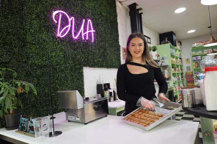 Alexandra Lulaj , owner of DUA Gourmet Market in Arthur Avenue Market, poses with her imported baklava. The business celebrates its one-year anniversary on March 26.
