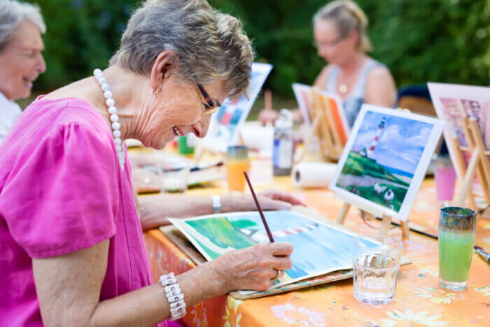 Seniors paintinng watercolor outdoors