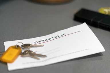 a stock photo shows keys and an eviction notice