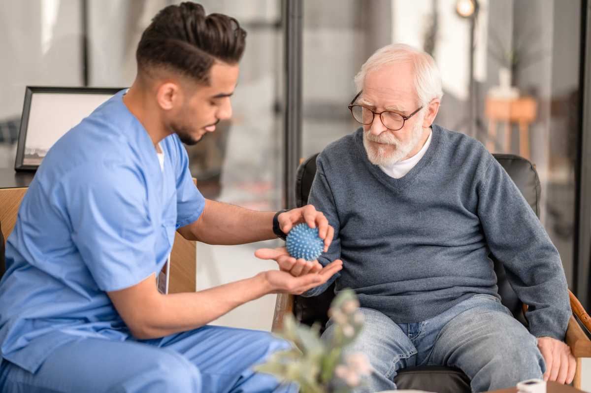 Concentrated physiatrist conducting a physiotherapy session