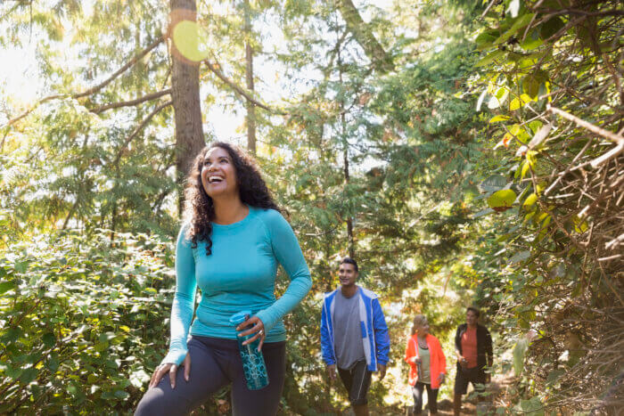 People/family hiking through a forest.