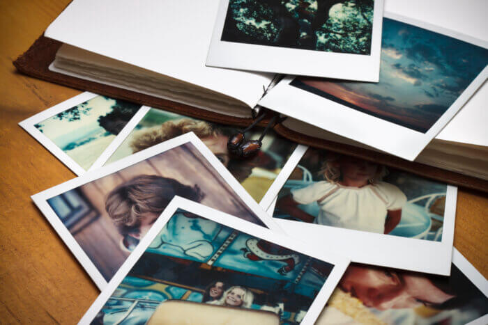 Printed Polaroid pictures and a blank book.