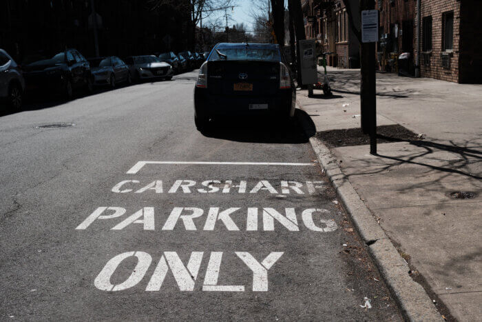 a parking spot is painted to say carshare parking only