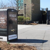 Macombs Dam Park garbage can with advertisement that says: Lets make NYC clean and rat free, a little litter can lead to big problems