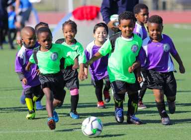 Group of little kids playing soccer for South Bronx United, a Bronx-based nonprofit.