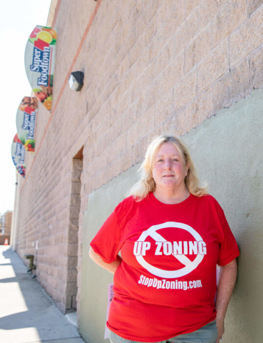 Carol Brumley-McManus wears a shirt with the website for the Coalition Against Up Zoning Inc. at one of the Bruckner rezoning project sites on Tuesday, Sept. 30, 2022.