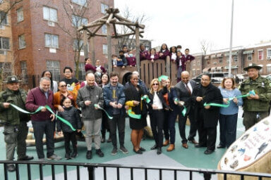 NYC Parks Commissioner Sue Donoghue and Bronx Borough President Vanessa Gibson attend the ribbon cutting ceremony for the newly constructed Corporal Irwin Fischer Park alongside community members.