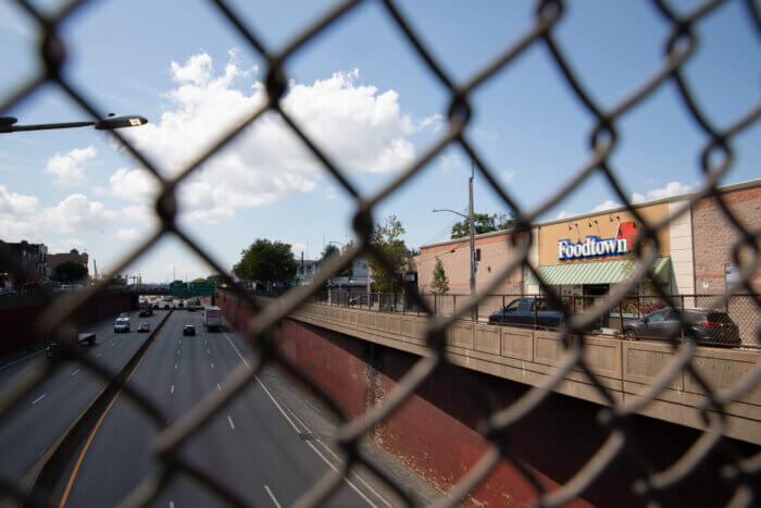 view of the Bruckner Boulevard Super Foodtown and Bruckner expressway through a fence