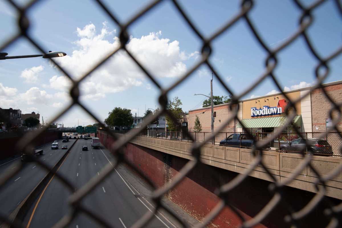 view of the Bruckner Boulevard Super Foodtown and Bruckner expressway through a fence