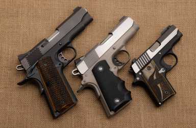 Semi automatic handguns on  burlap background , 1911 the same of Single Action