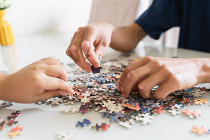 hands doing puzzles