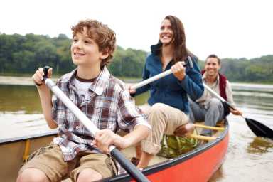 Family on a boat on a lake.