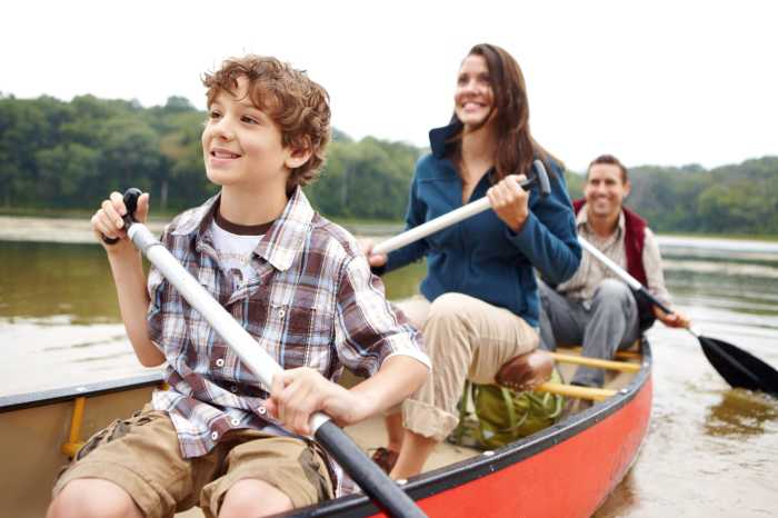 Family on a boat on a lake.