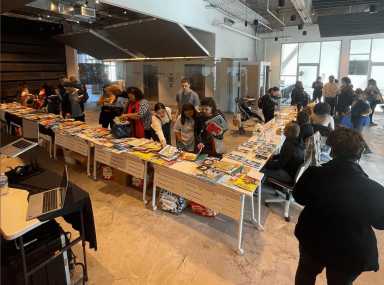 Wide angle picture of people at Loc'd and Lit's free book event, called "Books in Bloom," on April 1.