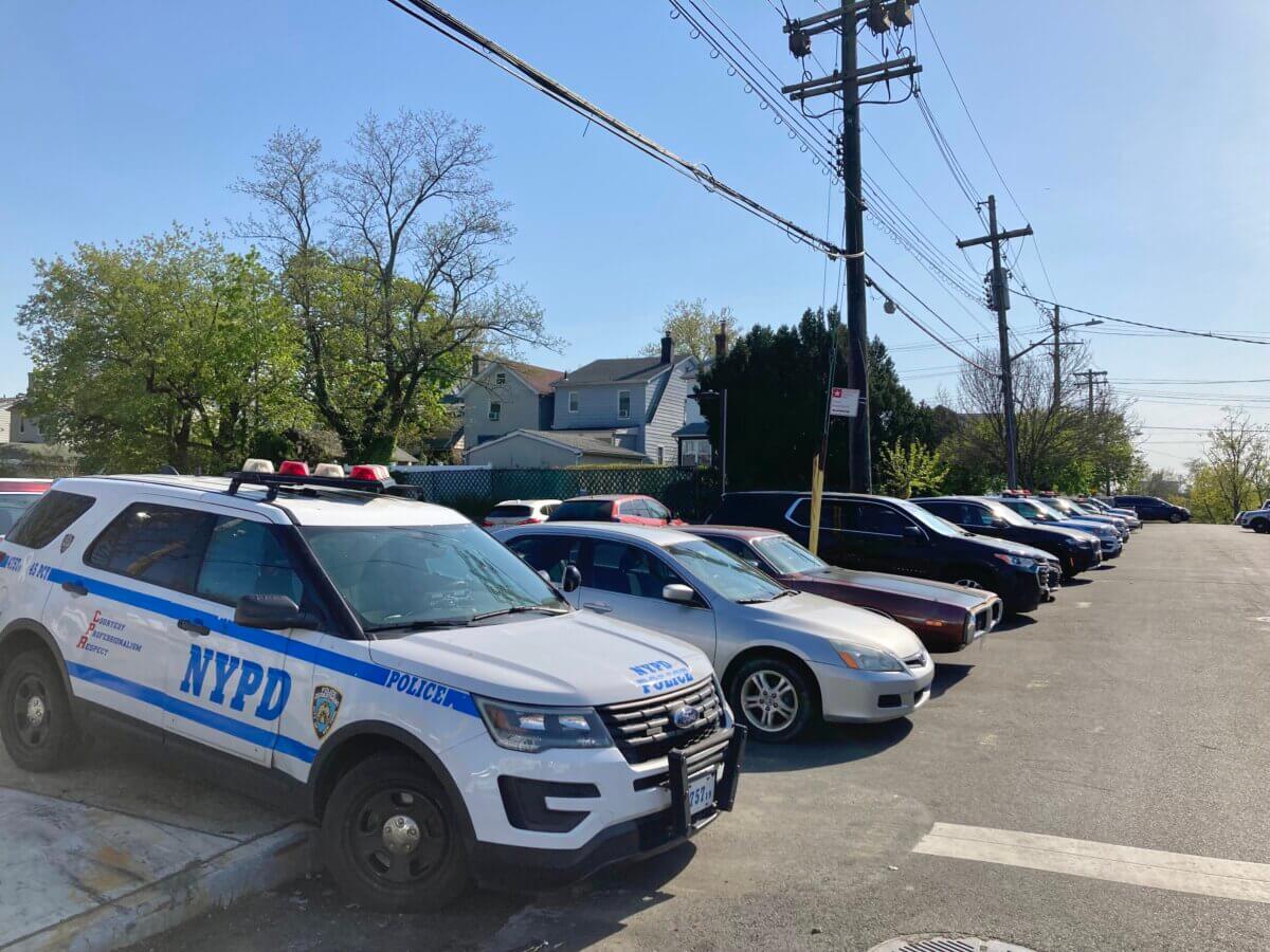 Vehicles line the sidewalk surrounding a sign that says Authorized Vehicles Only Police Department