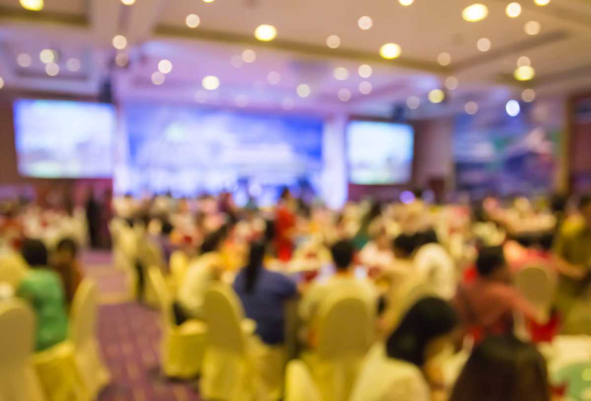 blur people  sitting in dining room with projecting monitor