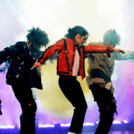 Michael Jackson impersonator dances with backround dancers and a backdrop of colorful lighting.