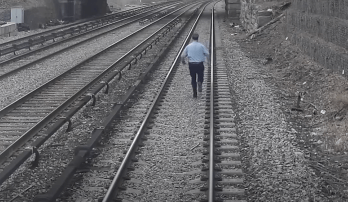 Metro-North Assistant Conductor Marcus Higgins runs to rescue a 3-year-old child who was approaching the electric third rail on the Hudson Line just north of Tarrytown, New York on Thursday, April 6, 2023.
