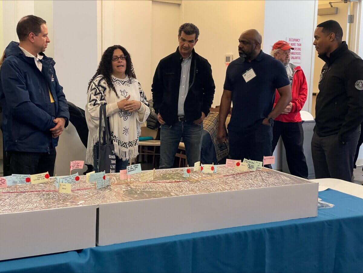 people gathered around a map of the Cross Bronx Expressway