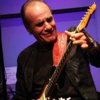 Lou Volpe plays guitar