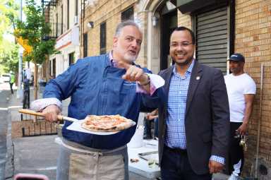 council Member Oswalsd Feliz stands with small businesses owner, David Greco of Mike's Deli.