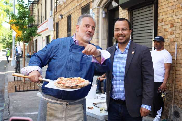 council Member Oswalsd Feliz stands with small businesses owner, David Greco of Mike's Deli.
