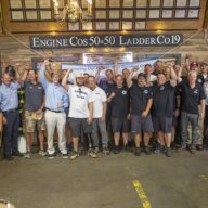 Evan Marcy was awarded his home at the Engine 50, Ladder 19 station where his father worked. Marcy is pictured center left with Building Homes for Heroes Founder and CEO Andy Pujols on his left and retired FDNY Captain Mike Alexander on his right.