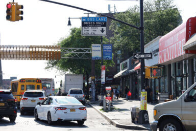 Despite the schedule posted above, cars still blocked the bus lane on Fordham Road on a Tuesday afternoon.