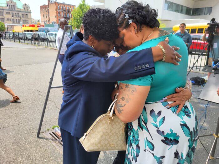 Yanely Henriquez is comforted by Bronx District Attorney Darcel Clark June 20, 2023