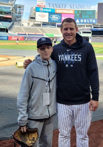 Anthony Rizzo alongside a fan at Yankee Stadium.