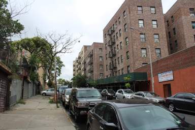 Cars line the street of the Fordham section of the Bronx on Monday, June 12, 2023.