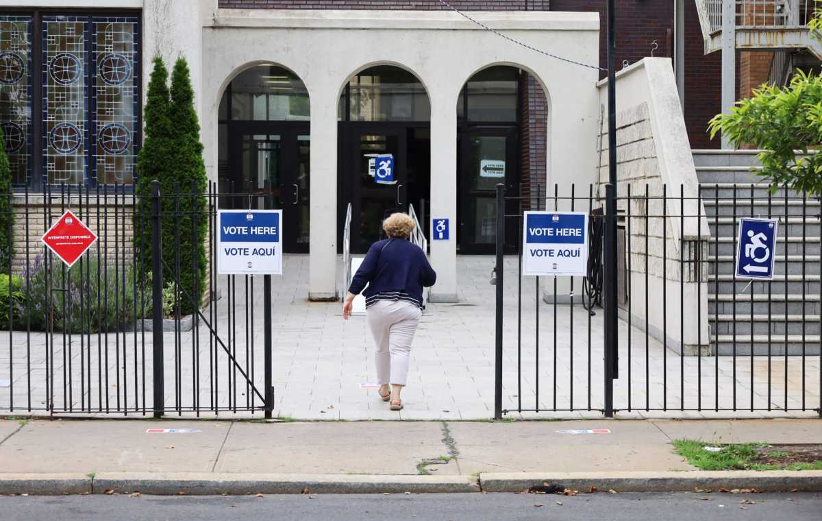 A woman enters the Greek American Institute at 3573 Bruckner Blvd. to cast her vote during the New York City Primary Election on Tuesday, June 27, 2023.