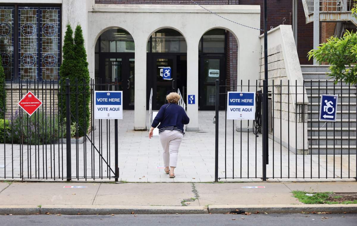 A woman enters the Greek American Institute at 3573 Bruckner Blvd. to cast her vote during the New York City Primary Election on Tuesday, June 27, 2023.