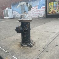 An open fire hydrant is seen on E. Tremont Avenue in Throggs Neck on Friday, June 9, 2023.