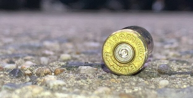 Police officers find the shell casing of a 9mm bullet after a shooting in the Crotona Park East section of the Bronx on Friday, June 16, 2023.