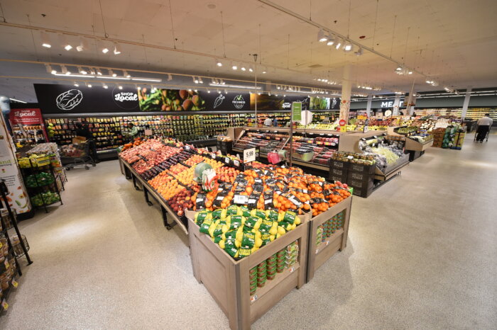 photo of inside grocery store with food on racks