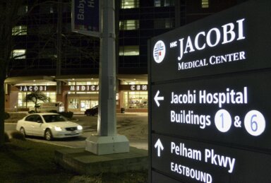 sign for Jacobi Medical Center lit up at night
