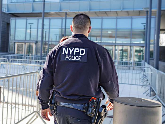 NYPD Neighborhood Safety Teams officers wear black uniforms with white lettering and drive unmarked cars. They are responsible for engaging with residents in an effort to combat gun violence. Photo Dean Moses