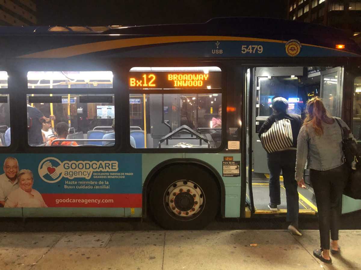 People board a Bx12 bus in Fordham.