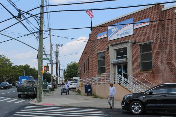 People come out of a post office on Gun Hill Road in the Bronx on Tuesday, July 25, 2023.