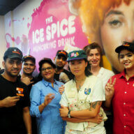 Muralist Kamille "OG Millie" Ejerta poses with Dunkin' Donuts staff after painting a mural celebrating a new collaboration with Bronx-born rapper Ice Spice on Wednesday, Sept. 20, 2023.