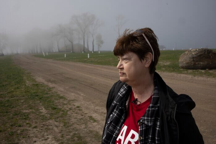 Radio Diaries and Radiotopia are launching a new podcast called "The Unmarked Graveyard: Stories from Hart Island." Pictured, Susan Hurlburt visits her son's grave on the island.