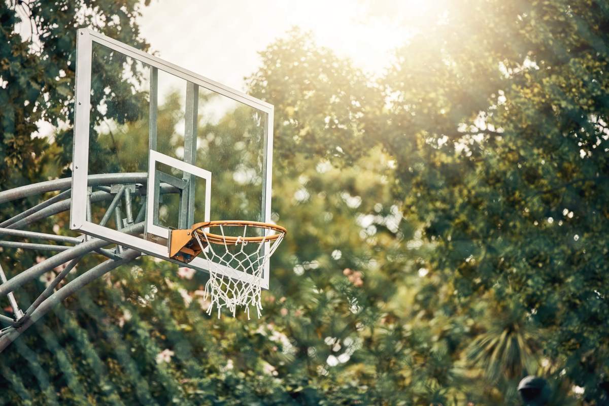 Nature, basketball court and basket for fitness training and game tournament score exercise. Outdoor sports venue net for competition goal practice and cardio workout with sunshine flare.