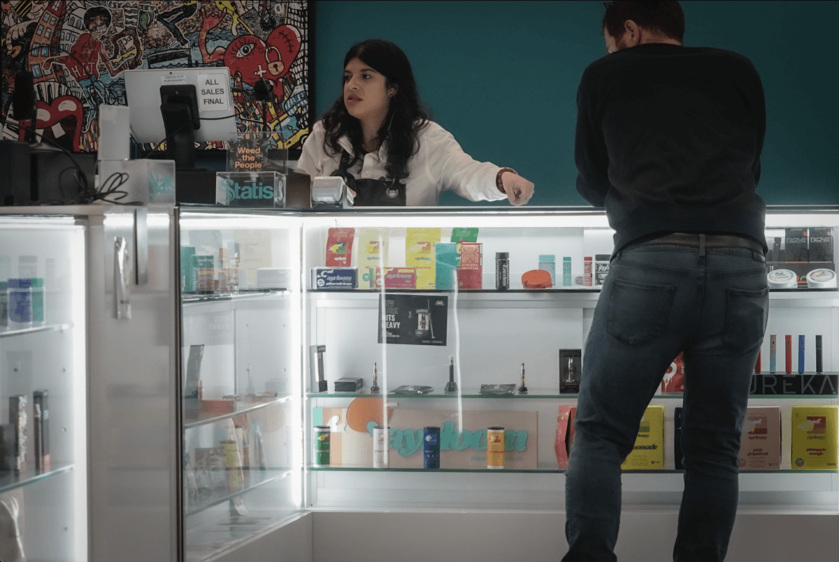 Alex Silecchia, left, a marijuana "budtender," also known as a sales associate, serves a customer at Statis Cannabis Company dispensary, Friday, Sept. 29, 2023, in the Bronx.