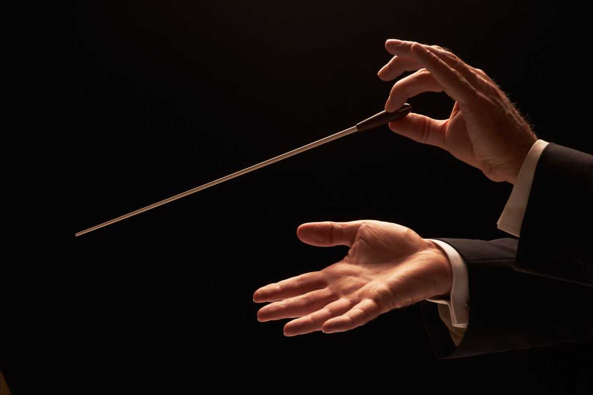 Concert conductor hands with baton
