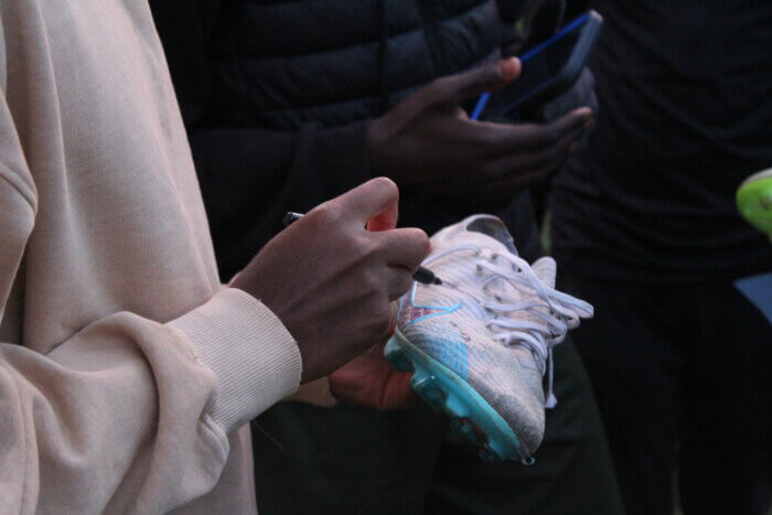 NYCFC defender Tayvon Gray signs players' cleats at a CITC practice in Crotona Park on Wednesday, Nov. 8, 2023.