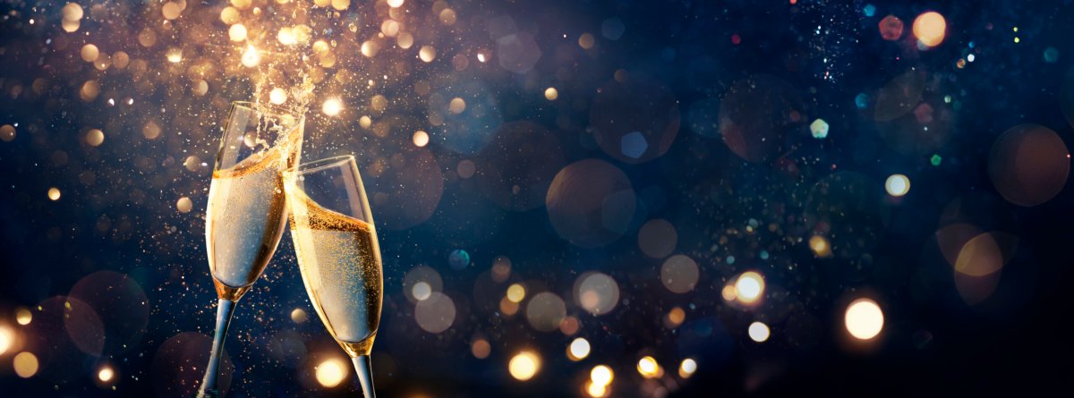 Champagne Toast Celebration – Happy New Year – Flutes With Golden Glitter On Blue Abstract Background With Defocused Bokeh Lights