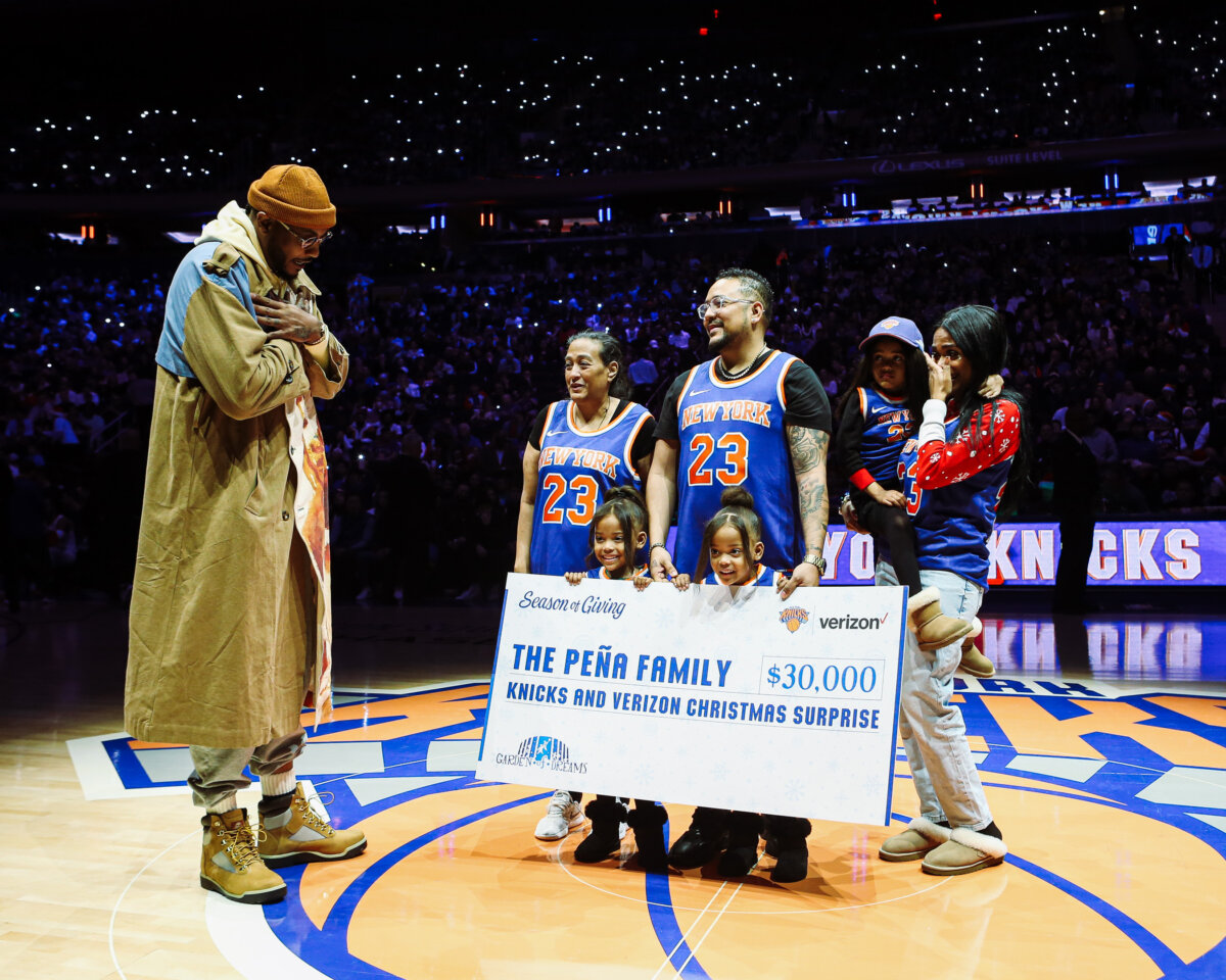 At the Christmas Day game, New York Knicks legend Carmelo Anthony surprised the Pena family with a $30,000 check from the Garden of Dreams Foundation. Photo courtesy MSG Sports