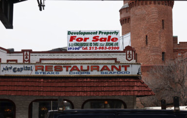A "for sale" sign looms above the New Capitol Restaurant at 2 Kingsbridge Road on Thursday, Dec. 7, 2023, which has been serving the neighborhood Hispanic and diner classics for 55 years.
